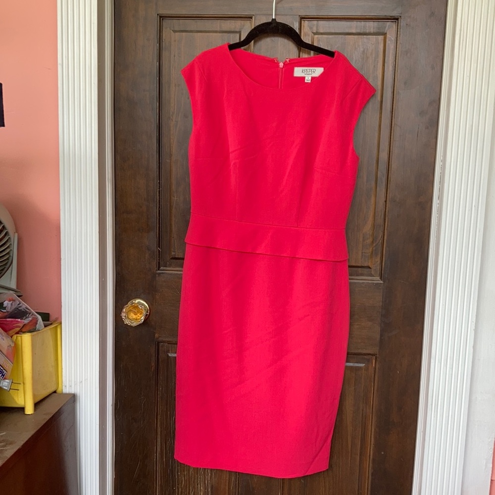 Hot pink sleeveless dress with short front peplum.